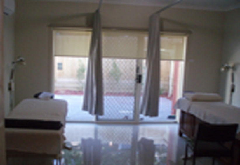 Treatment room with beds and window